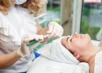 Midsection of doctor examining patient at clinic