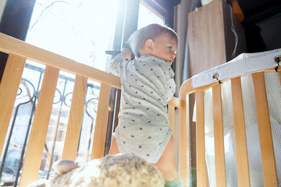 Low angle view of woman looking at railing