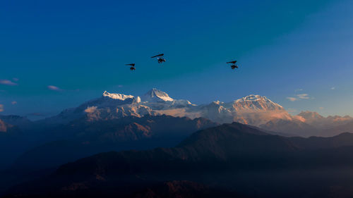 Scenic view of mountains against blue sky