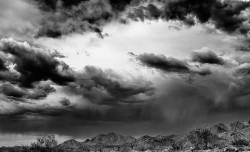 Rocky mountains against cloudy sky