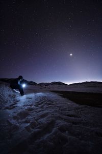 Scenic view of land against sky at night