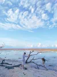 Woman on beach against sky