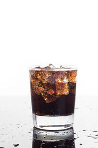 Close-up of ice cream in glass against white background