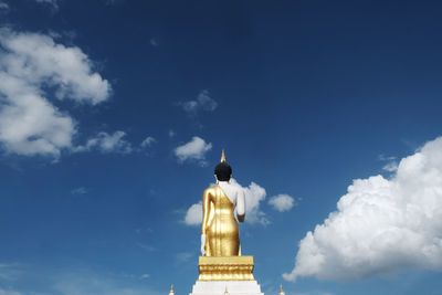 Low angle view of statue against building against sky