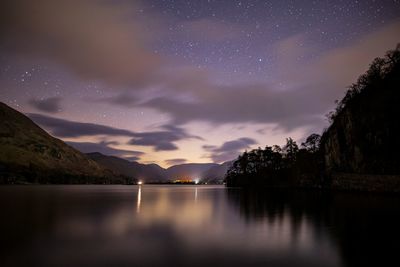 Scenic view of lake against sky at night