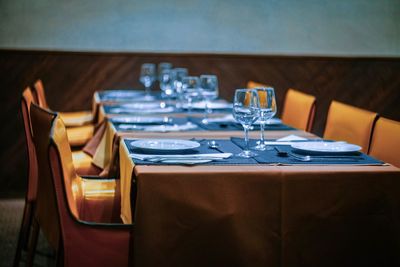 Plates and glasses on table in restaurant