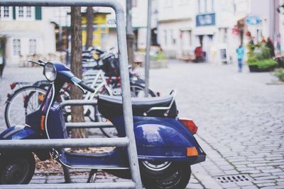 Close-up of scooter on street in city