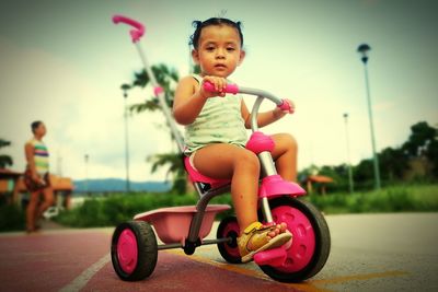 Cute boy riding motorcycle on road