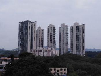 Buildings in city against sky