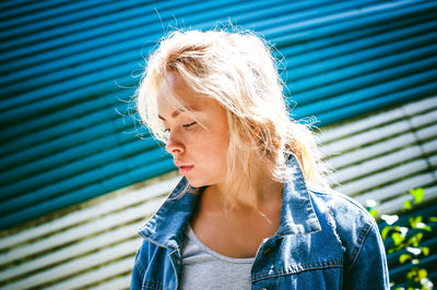 Portrait of young woman standing outdoors