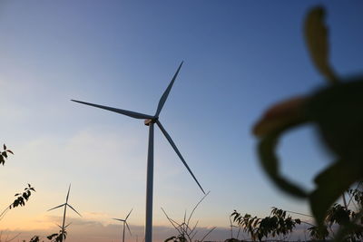 Low angle view of windmill against sky during sunset