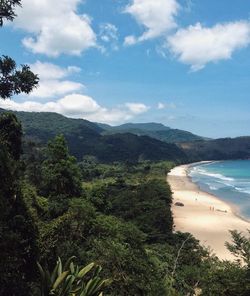 Scenic view of landscape by sea against sky