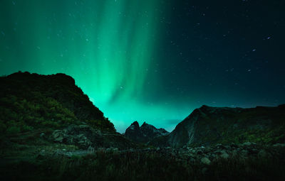 Scenic view of mountains against sky at night