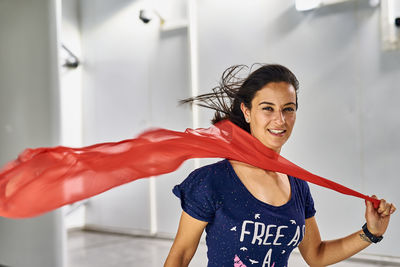 Portrait of smiling woman holding scarf