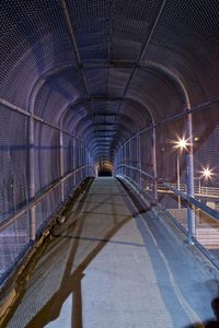 Illuminated covered bridge at night