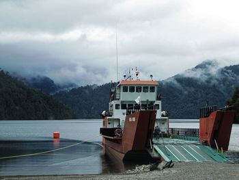 Ship moored on sea against sky