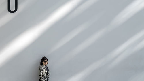 Woman standing against wall