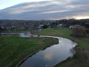 Scenic view of river against sky during sunset