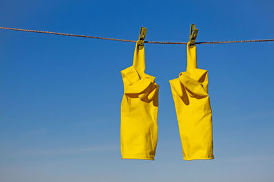 Low angle view of clothes hanging against clear sky