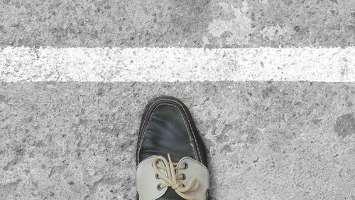 Low section of person standing on tiled floor