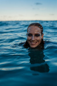 Young woman swimming in sea