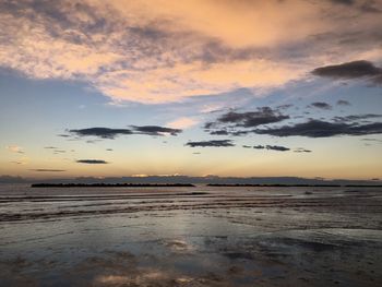 Scenic view of beach against sky during sunset