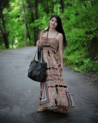 Portrait of young woman standing outdoors