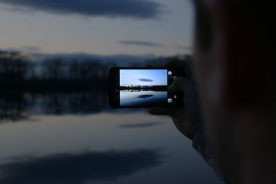 Photographer taking picture of a mobile phone