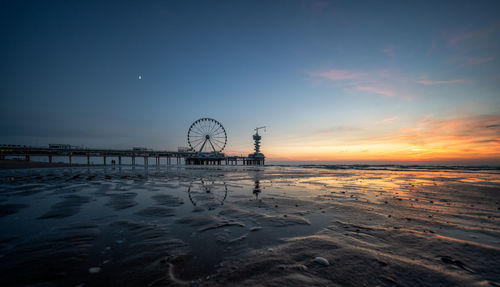 Scenic view of beach against sky during sunset