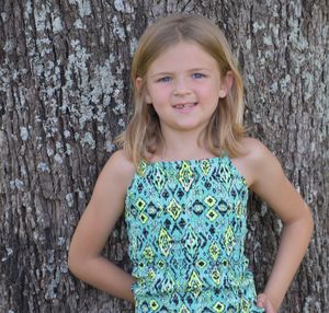 Portrait of a smiling girl standing outdoors