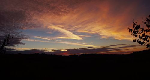 Silhouette of landscape against sky at sunset