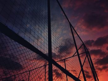 Low angle view of fence at sunset