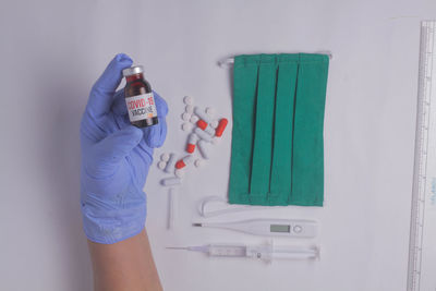 Midsection of man working on white wall