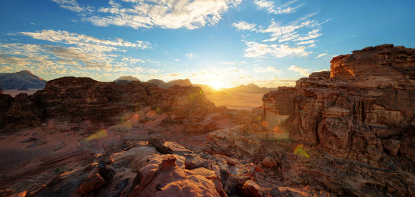 Scenic view of rock formations against sky during sunset