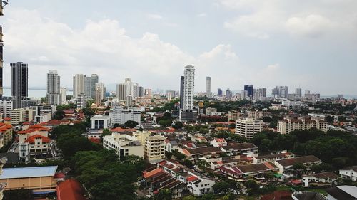 High angle view of buildings in city against sky