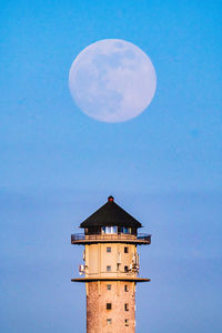 Low angle view of tower against sky at night