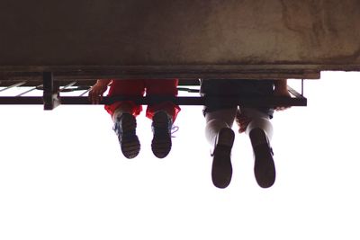 Low section of men standing on bridge