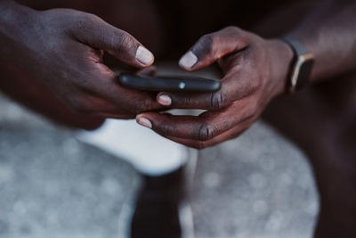 Male athlete using smart phone outdoors