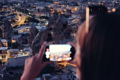 Close-up of woman photographing cityscape