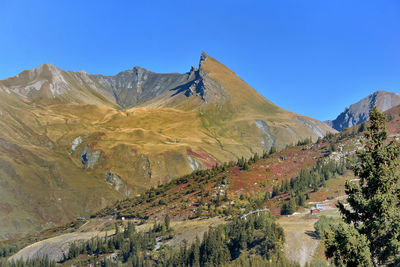 Scenic view of mountain range against blue sky