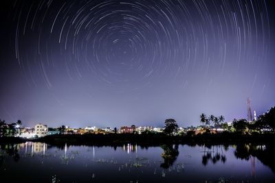 Scenic view of lake against sky at night