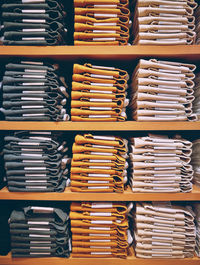Full frame shot of folded clothes in shelf at store for sale