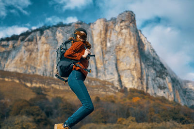 Full length of young woman on rock