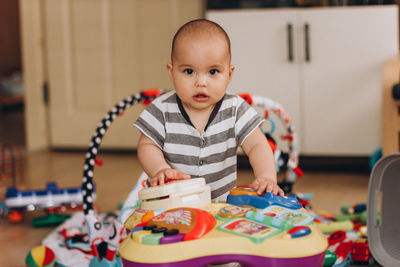 Portrait of cute boy with toy at home