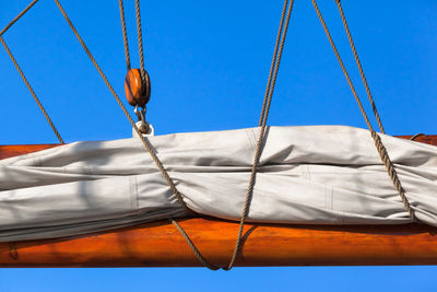 Low angle view of swing hanging on rope