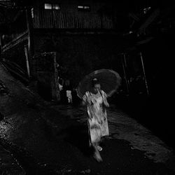 Full length of woman standing at night