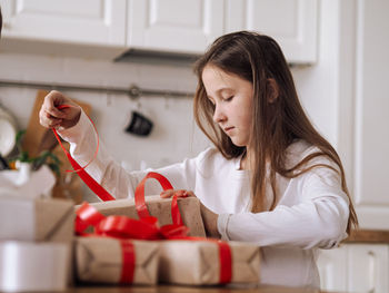 Portrait of young woman holding gift