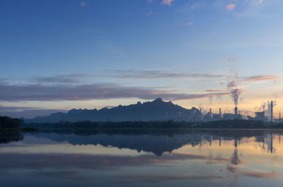 Coal power plant and water reflection in the morning among the mountains and lakes. 