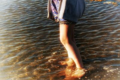 Low section of woman in water