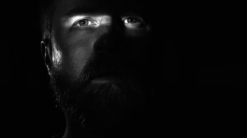 Slit of light across a man's eyes black and white